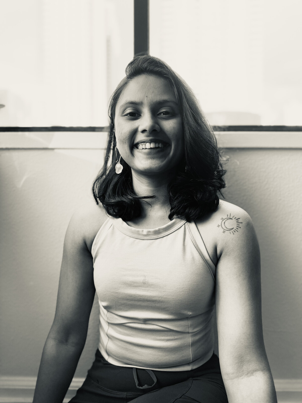 Medha smiling, a portrait moment from her practice