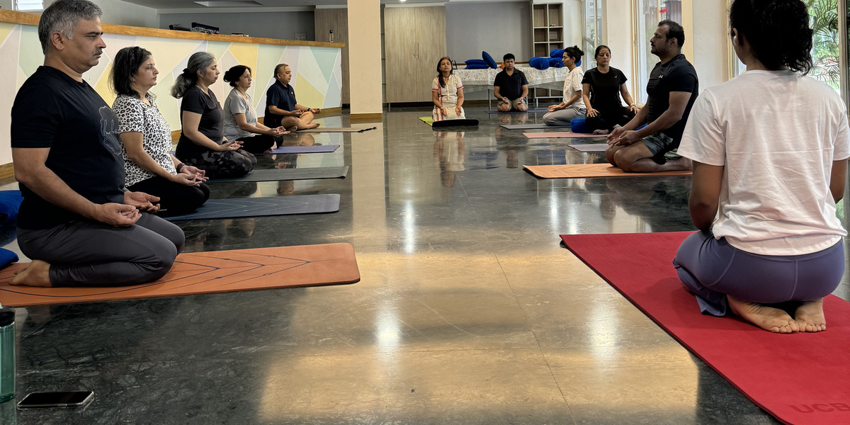Medha leading a group yoga class in the studio