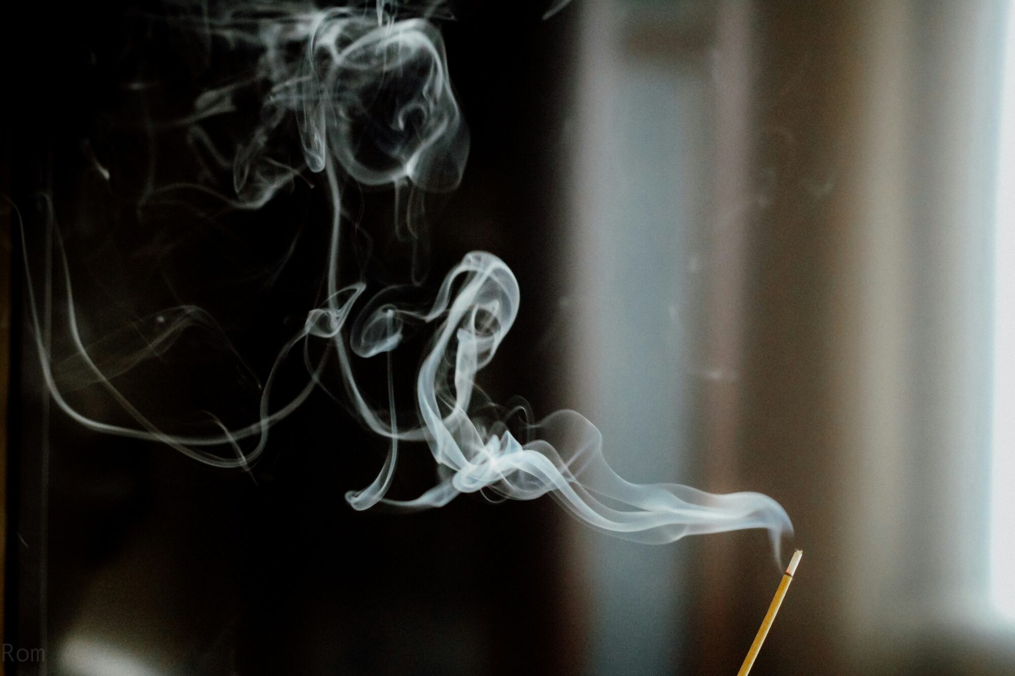 Incense smoke curling upward, a moment of quiet focus
